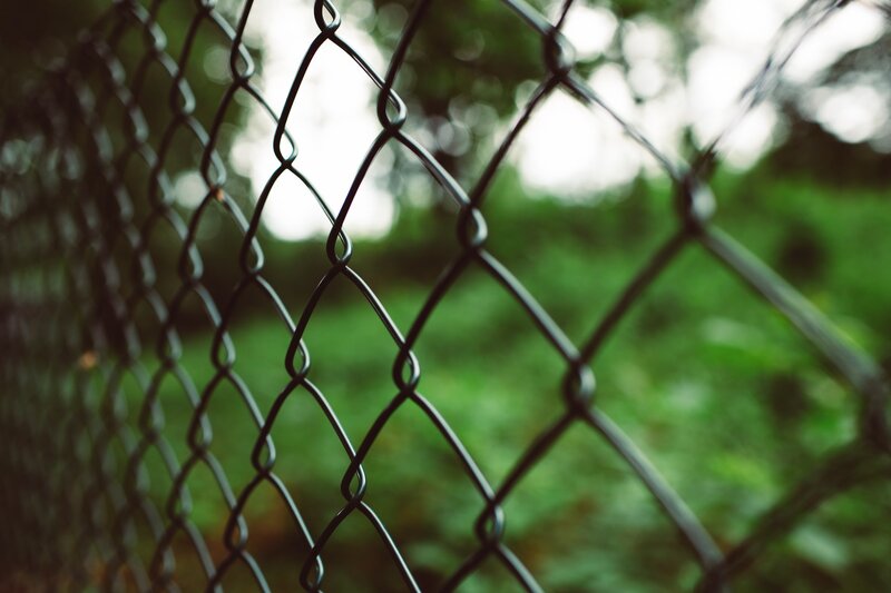 A beautiful chain link fence with green background