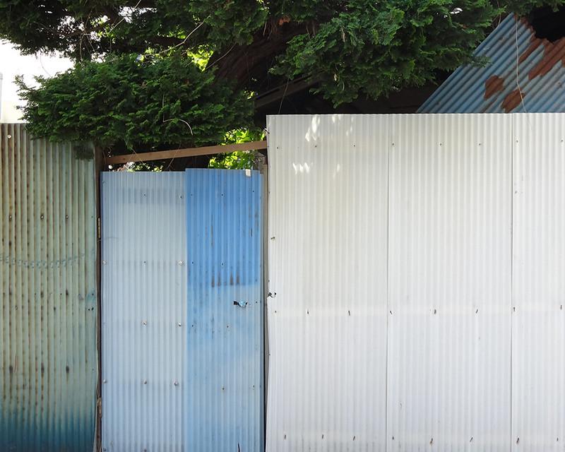 Uneven fence line with different colored materials